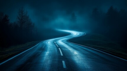 Winding road through a misty, dark night