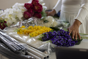 Florist arranging artificial flowers for event decoration