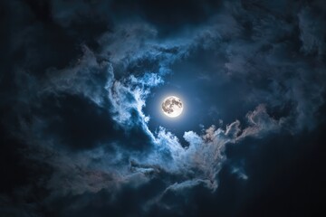 Full moon peeking through dark, stormy clouds