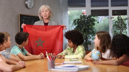 children listen with interest to teacher, who talks about geographical location of Morocco - Powered by Adobe