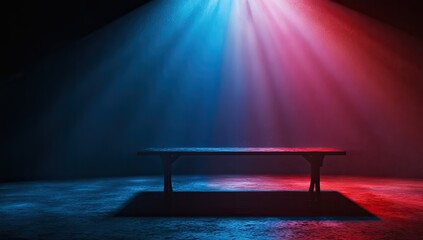 A dark room, illuminated by vibrant blue and red spotlights converging on a simple, rustic wooden table, creating a dramatic, moody atmosphere