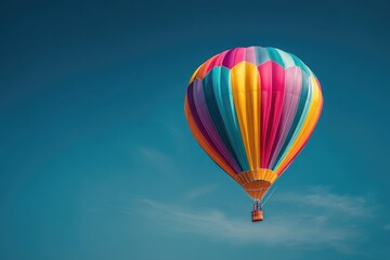 Fototapeta premium Colorful hot air balloon soars against a vibrant blue sky