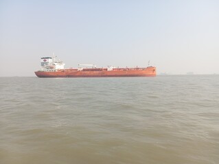 Large red oil tanker on calm sea waters, a Cargo ship used for maritime transport and freight shipping. Industrial vessel reflecting global shipping operations and offshore cargo transportation at sea