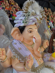 Newly made idols of the God known as Ganesha or Ganapati for sale at a shop on the eve of Ganesh festival in Pune, India.