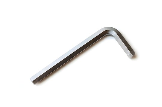 A close up shot of a single silver allen wrench tool isolated on a plain white background in a studio shot