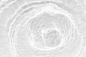 White water with ripples on the surface. Defocus blurred transparent white colored clear calm water surface texture with splashes and bubbles. Water waves with shining pattern texture background.