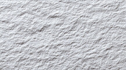 Close-up view of textured, light gray surface.  Rough, uneven surface with subtle ridges and bumps