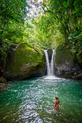 Girl swimming at a waterfall in Uvita