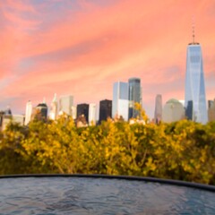 Blurred city skyline at sunset over a pool