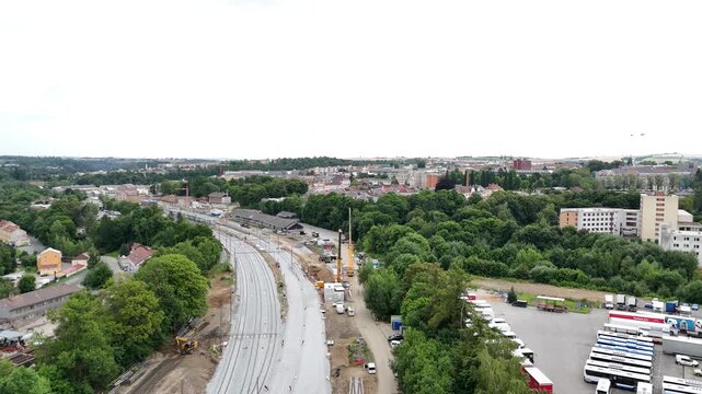 Drone aerial view of a giant construction crane lifting massive concrete structures at a mega building site, symbolizing strength, engineering progress, and the scale of modern industry.