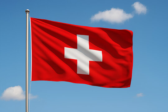 The Swiss flag waves against a bright blue sky with clouds. - Powered by Adobe