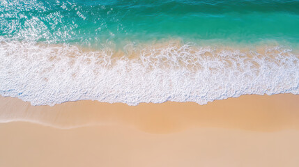 Aerial view of serene beach with gentle waves lapping on soft sand, creating tranquil atmosphere