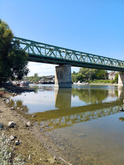 Fototapeta premium Green Steel Bridge over Calm Waters