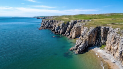 Coastal cliffs with hiking trail overlooking serene blue sea create breathtaking view