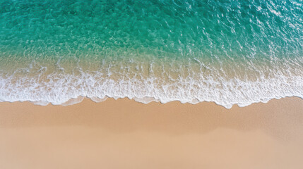 Aerial view of serene beach with gentle waves lapping against soft sand, creating tranquil scene