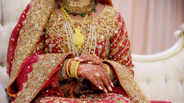 Bride hold the bangles on hand while posing for photo shot, dressed in red traditional Indian clothes, Elements of hindu wedding. 