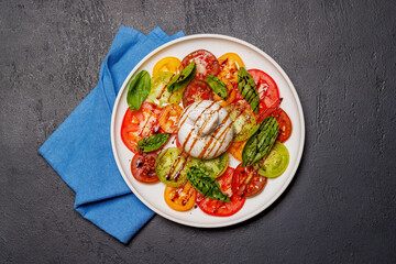 Fresh burrata served on slices of colorful tomatoes
