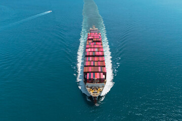 Container ship heavy ship goes on water, cargo in the sea strait around islands entering the port, aerial top straight view directly from air from above