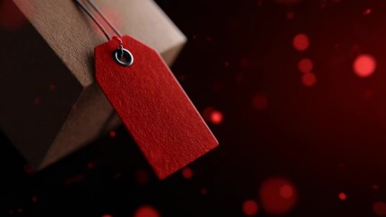 Red tag label hanging from a brown box against a blurred dark background with red particles visible - Powered by Adobe