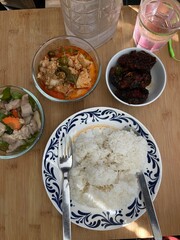A healthy Thai chicken and rice bowl with fresh vegetables for a delicious lunch