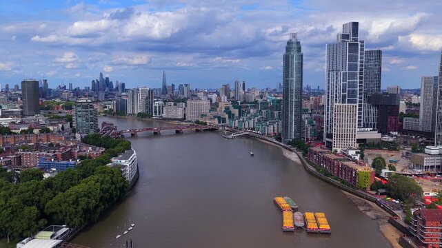 Aerial video of Vauxhall riverfront in South London where the River Thames curves past a cluster of bold modern skyscrapers	