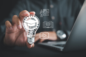 Learn e learning via technology, hand holds lightbulb filled with gears and graduation cap icon, teacher book and video icons float, and you can also learn from global creative experience displayed