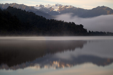 Mount Tasman, New Zealand taken from lake Mapouriko near the village of Fox Glacier. Nice reflection of the whole scene in the water of the lake.