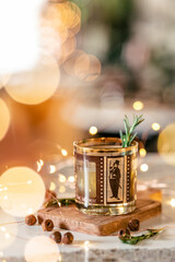 Holiday whiskey drink with rosemary garnish and twinkle lights.