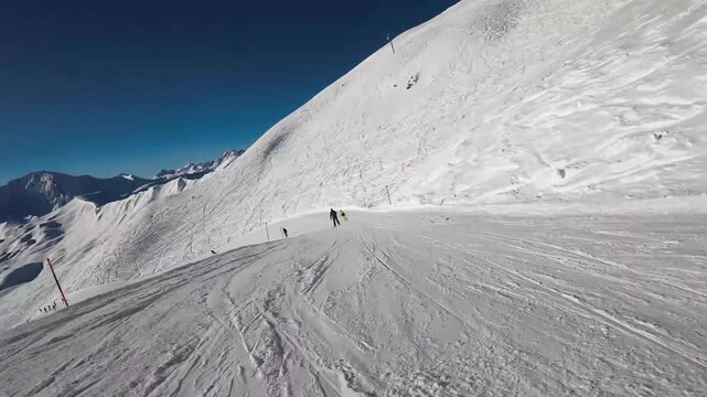 Speedy alpine skiing down a sunny mountain slope