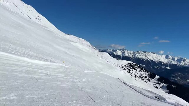 Smooth downward travel along a wide mountain slope