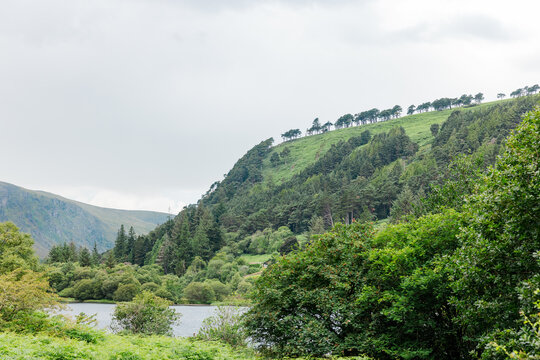 Lush green hills and lake at Glendalough in Wicklow, Ireland