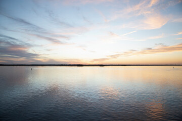 reflection of colorful soft sunset on the ocean horizon