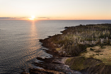 aerial view of sunset and shoreling of wild treelined island