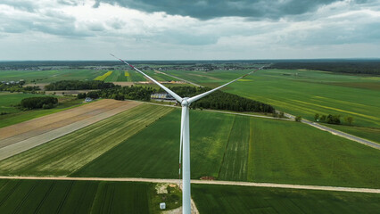 Industrial windmill in lush green farmland