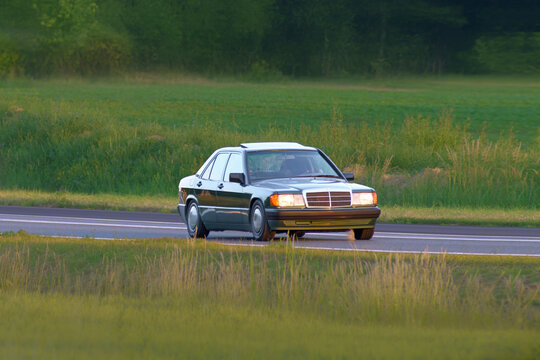 Preserved youngtimer with shiny paint on open road