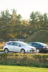 European city car traveling by rural highway