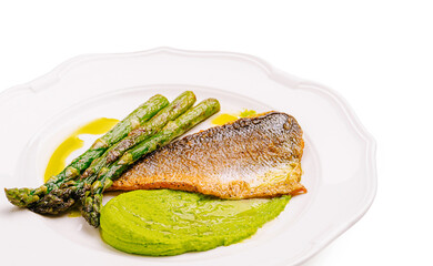 Freshly cooked fish fillet with asparagus and mint puree presented elegantly