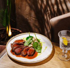Tasty grilled steak with spinach and creamy sauce at a cozy eatery