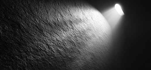 Fototapeta premium Dark stone wall illuminated by a spotlight