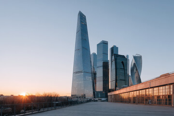 Obraz premium modern architectural facades of skyscrapers soaring against backdrop of breathtaking sunset