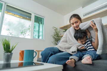 Obraz premium Family Bonding. Mother and child enjoying cozy time under blanket at home.