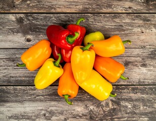 Colorful mini bell peppers arranged on a rustic wooden surface