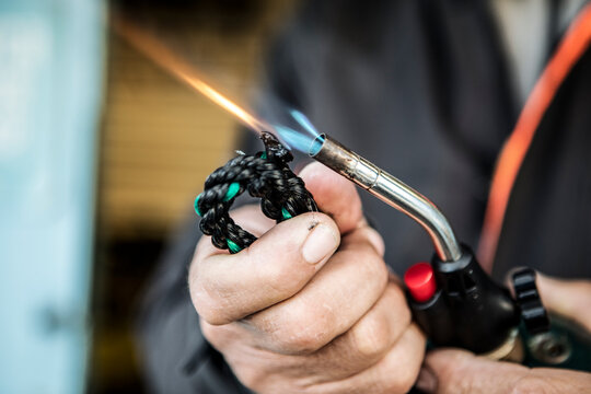 a fisherman used torch to seal braided rope line