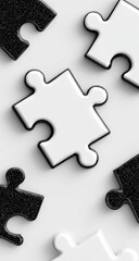 Fototapeta premium Black and white puzzle pieces scattered on a light background
