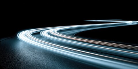 Light trails curve on a dark road