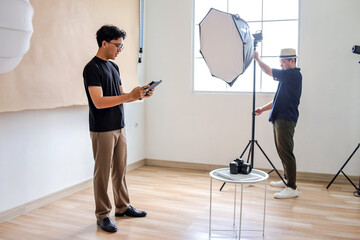 Two Male Doing Studio Preparation Scene With Teamwork Between Lighting And Digital Control