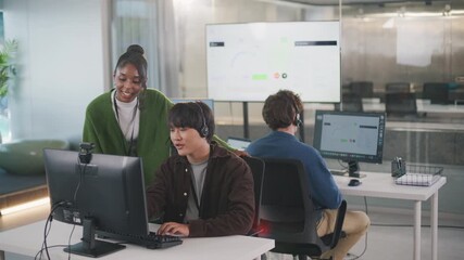 Call center customer support representative receives expert guidance from manager, leading team to provide exceptional service and professional assistance for each client - Powered by Adobe