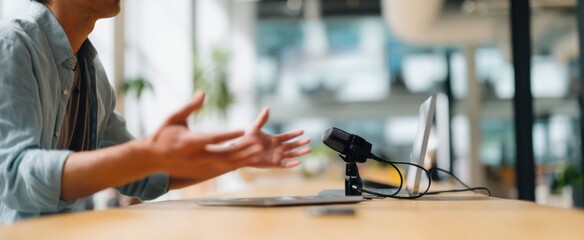 The person communicating passionately during an online meeting with a microphone.