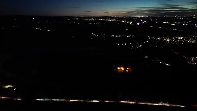 Hyper-lapse aerial footage of the rush traffic through Stonehouse town, England at night
