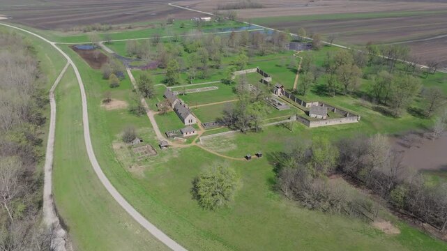 Aerial view of Fort de Chartres, stone buildings contrasting with the lush green landscape, and a path leading to the fort, Prairie du Rocher, Illinois, United States.